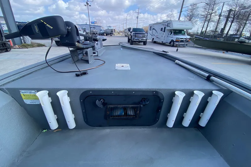 Slide: The Image of 1996 War Eagle 761 Renegade boat deck with rod holders and trolling motor. - 14