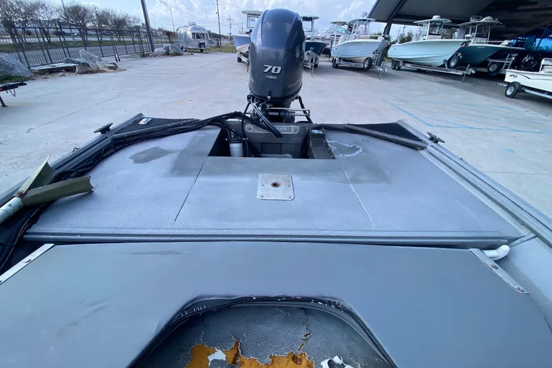 Slide: The Image of 1996 War Eagle 761 Renegade boat with 70 HP outboard motor in a marina. - 15