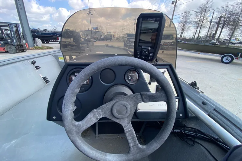 Slide: The Image of Interior view of a 1996 War Eagle 761 Renegade boat dashboard with steering wheel and gauges. - 17