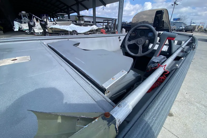Slide: The Image of 1996 War Eagle 761 Renegade boat interior with steering wheel and control panel. - 18