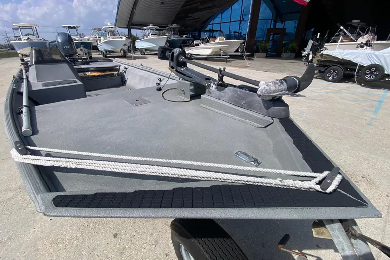 Slide: The Image of 1996 War Eagle 761 Renegade boat with trolling motor, parked in marina. - 20