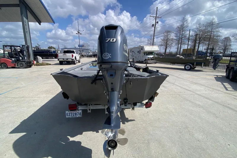Slide: The Image of 1996 War Eagle 761 Renegade boat with Yamaha 70 outboard motor at a dealership. - 5