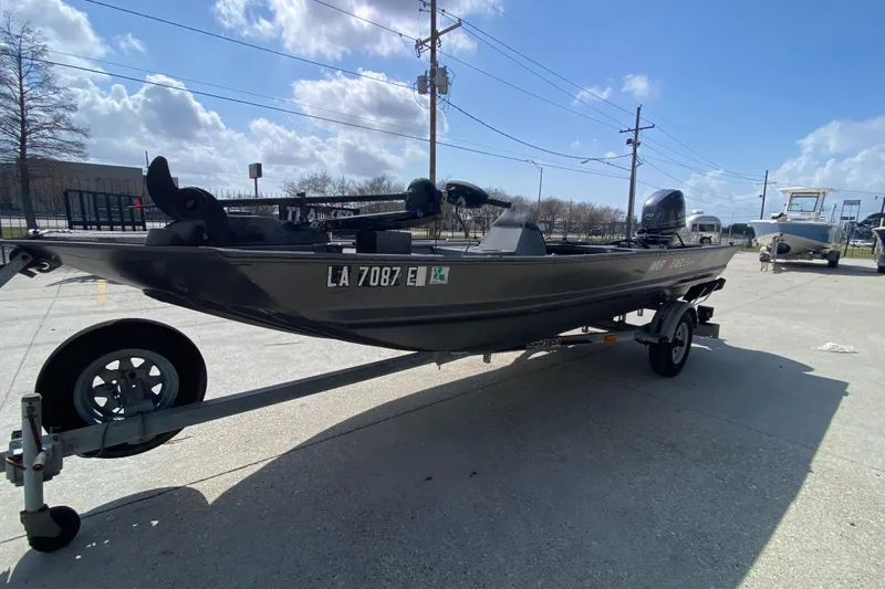 Slide: The Image of 1996 War Eagle 761 Renegade boat on trailer under a clear blue sky. - 9