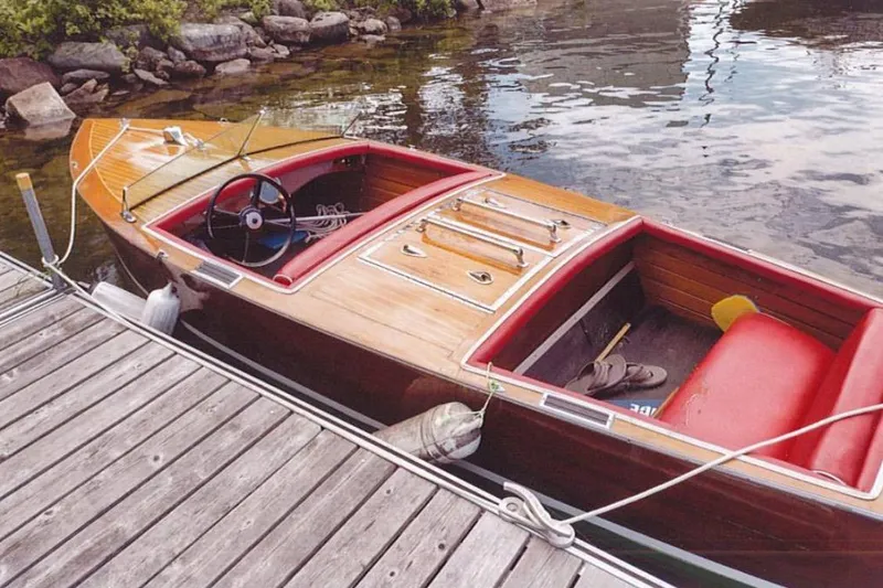 Slide: The Image of 1931 Dodge 16' Sea Nymph wooden boat docked by a lakeside pier. - 5