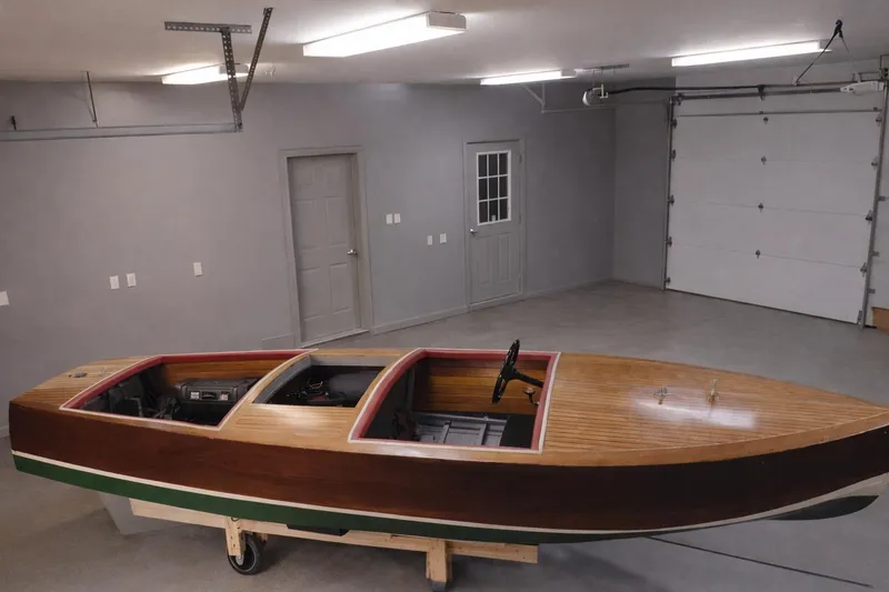 Slide: The Image of 1931 Dodge 16' Sea Nymph wooden boat in a spacious garage setting. - 7