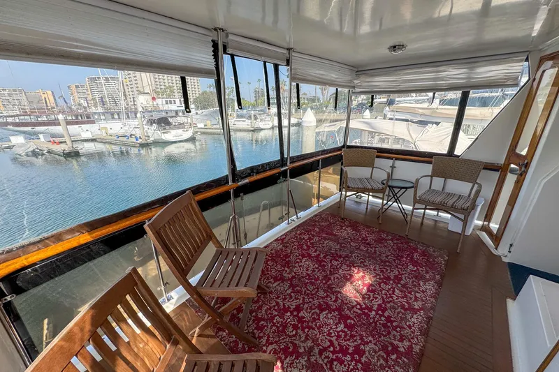 Slide: The Image of 1987 Lien Hwa 47 Elegant MK III yacht interior with chairs, rug, and marina view. - 11