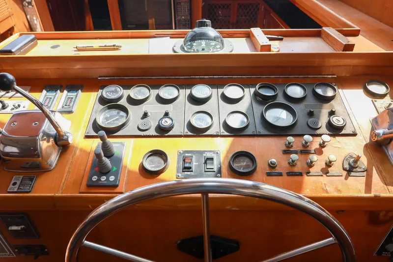 Slide: The Image of Control panel of a 1987 Lien Hwa 47 Elegant MK III yacht, featuring gauges and steering wheel. - 19