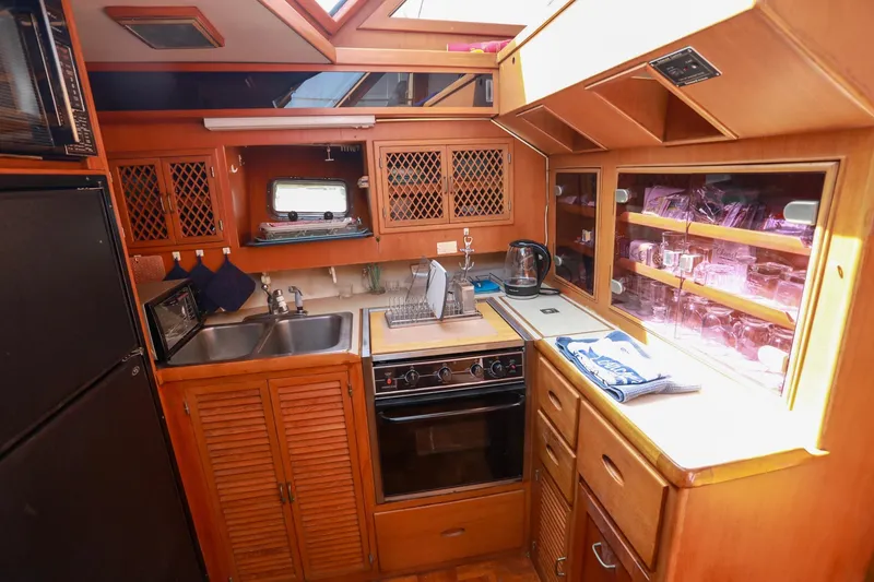 Slide: The Image of 1987 Lien Hwa 47 Elegant MK III yacht kitchen with wooden cabinetry and modern appliances. - 22