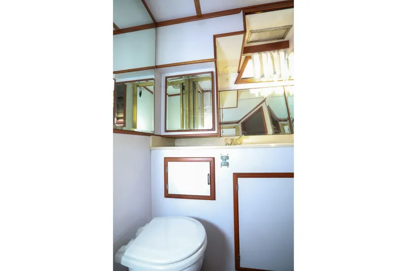Slide: The Image of Bathroom interior of 1987 Lien Hwa 47 Elegant MK III yacht, featuring mirrors and wooden accents. - 26