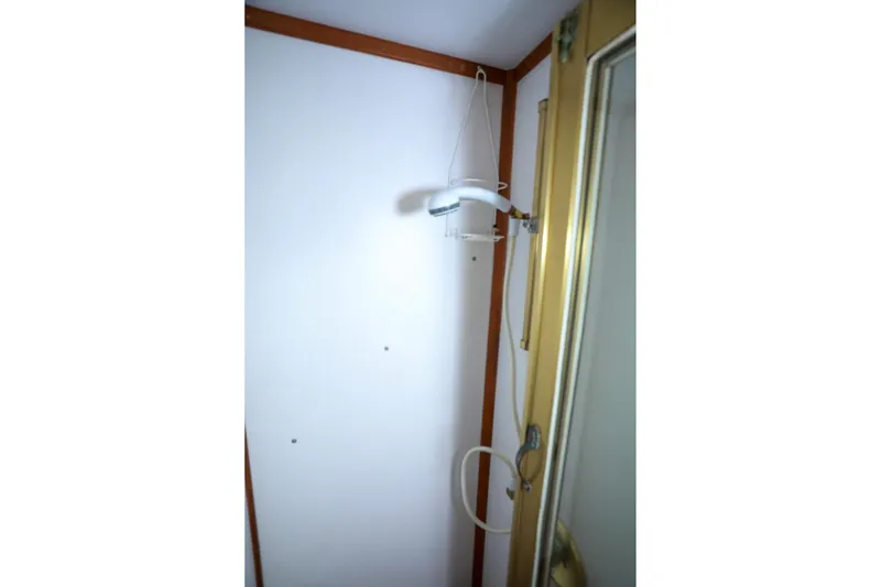 Slide: The Image of Shower area inside 1987 Lien Hwa 47 Elegant MK III yacht, featuring a handheld showerhead. - 28