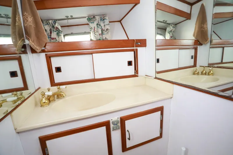 Slide: The Image of Elegant bathroom vanity in 1987 Lien Hwa 47 MK III yacht, featuring gold fixtures and wood accents. - 33