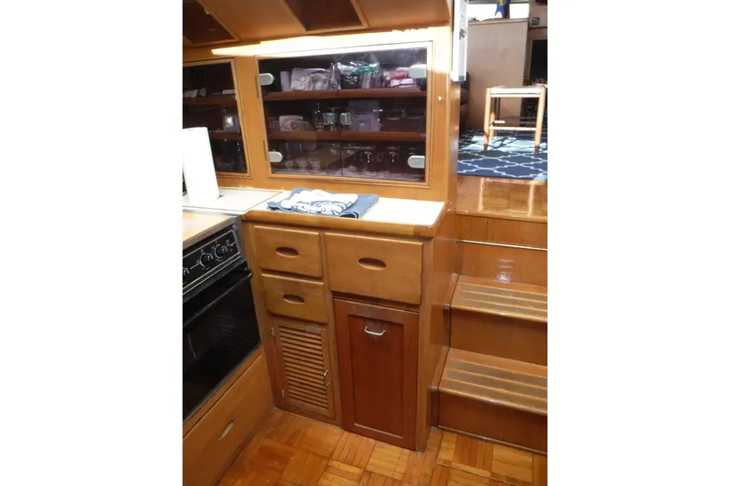 Slide: The Image of 1987 Lien Hwa 47 Elegant MK III yacht interior with wooden cabinetry and stairs. - 53