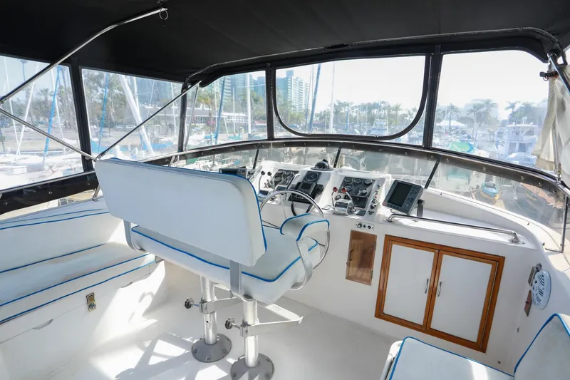 Slide: The Image of Cockpit of 1987 Lien Hwa 47 Elegant MK III yacht with white seating and navigation controls. - 8