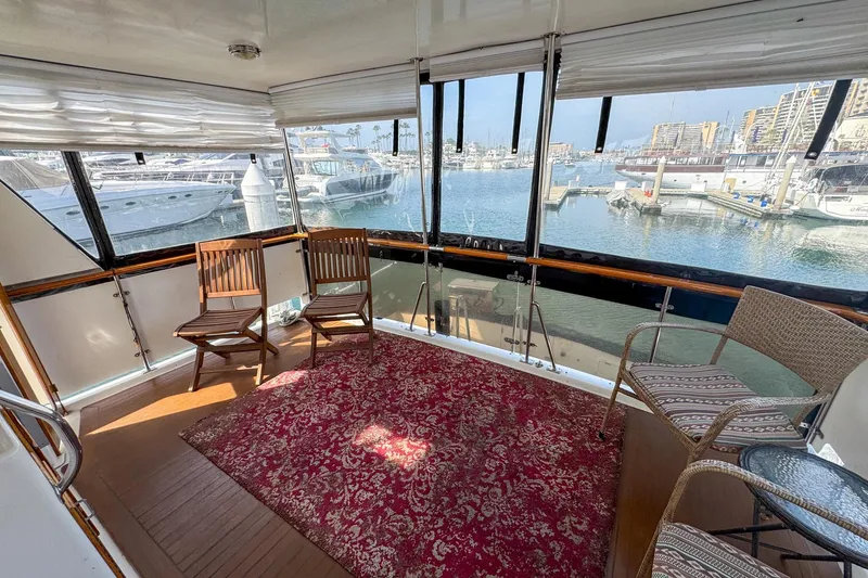 Slide: The Image of Sunlit interior of 1987 Lien Hwa 47 Elegant MK III yacht with marina view. - 9