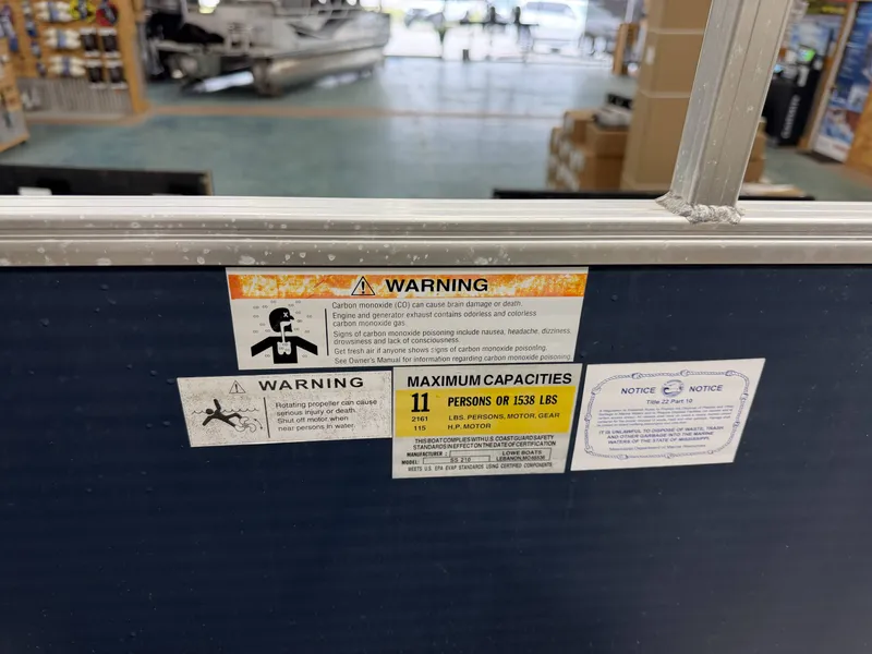 Slide: The Image of Warning labels on a 2014 Lowe SS 210 boat. - 12