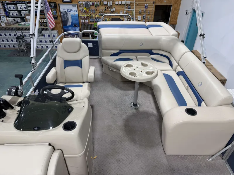 Slide: The Image of Interior of a 2014 Lowe SS 210 pontoon boat with beige and blue seating. - 16