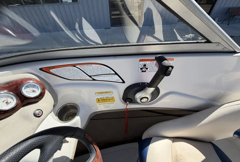 Slide: The Image of Interior view of a 2013 TAHOE - WRMG Q5i boat with controls. - 15