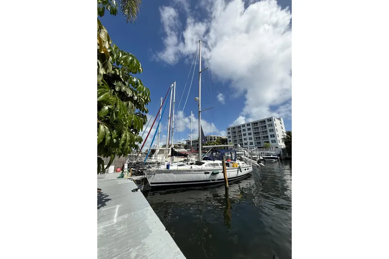 The Image of Sailboat Hunter Passage 420, 1997 model, docked in a marina under a clear blue sky. - 0