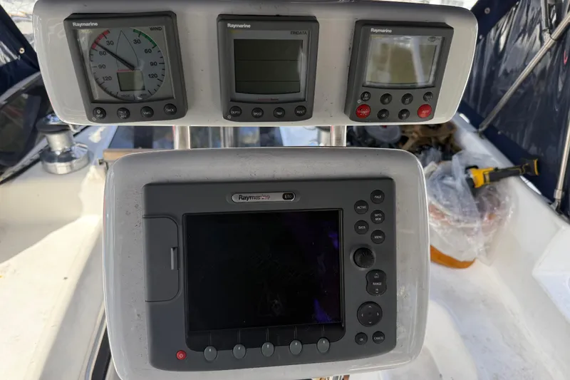 Slide: The Image of Cockpit instruments on a 1997 Hunter Passage 420 sailboat, featuring Raymarine displays. - 10