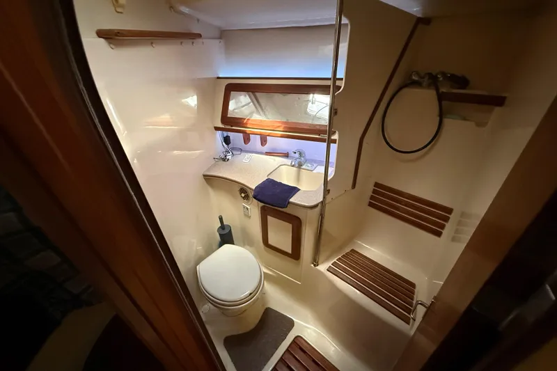 Slide: The Image of Cozy cabin interior of 1997 Hunter Passage 420 sailboat with floral bedding. - 21