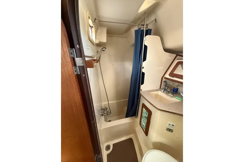 Slide: The Image of Engine compartment of 1997 Hunter Passage 420 sailboat, showcasing mechanical components. - 26