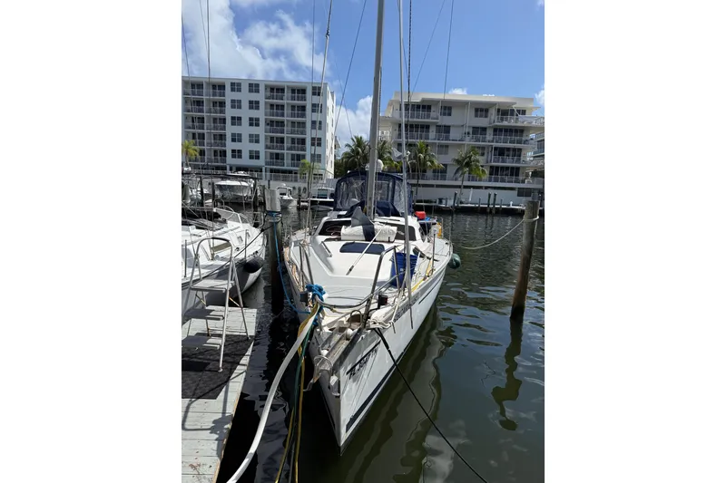 Slide: The Image of Sailboat docked at marina, 1997 Hunter Passage 420, with waterfront buildings in background. - 4