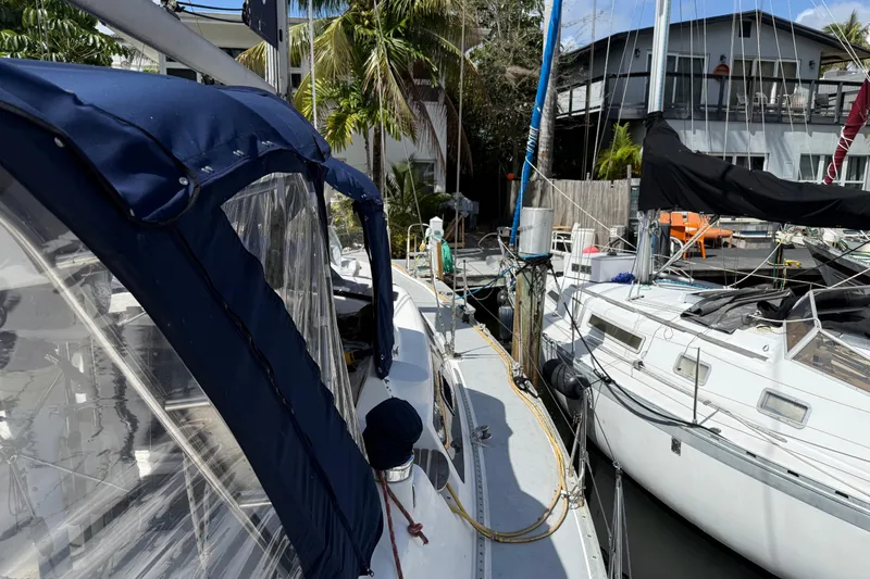 Slide: The Image of Hunter Passage 420 sailboat docked, 1997 model, with blue canopy and neighboring boats. - 5