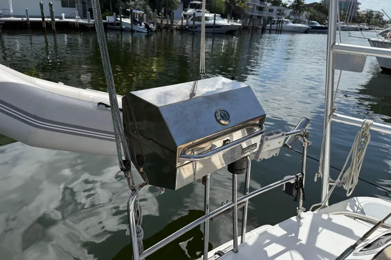 Slide: The Image of Stainless steel grill on 1997 Hunter Passage 420 sailboat, docked by the water. - 8