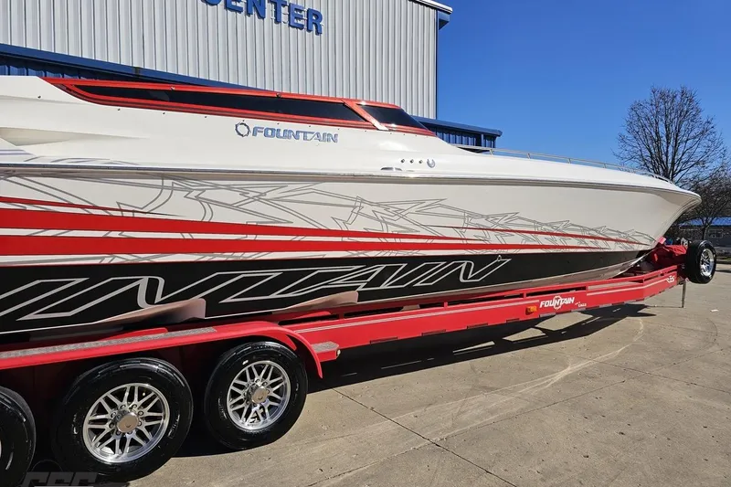 Slide: The Image of 2009 Fountain 47 Lightning boat on red trailer, parked outside a building. - 10