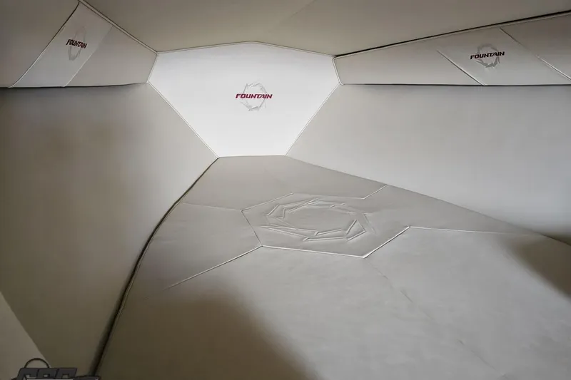 Slide: The Image of Interior cabin of 2009 Fountain 47 Lightning boat, featuring sleek white upholstery. - 104