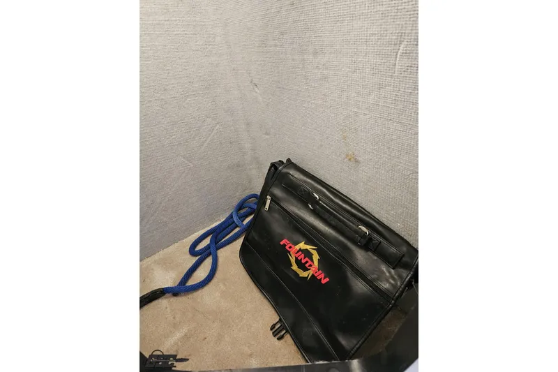 Slide: The Image of Black Fountain bag and blue rope in a 2009 Fountain 47 Lightning boat interior. - 105