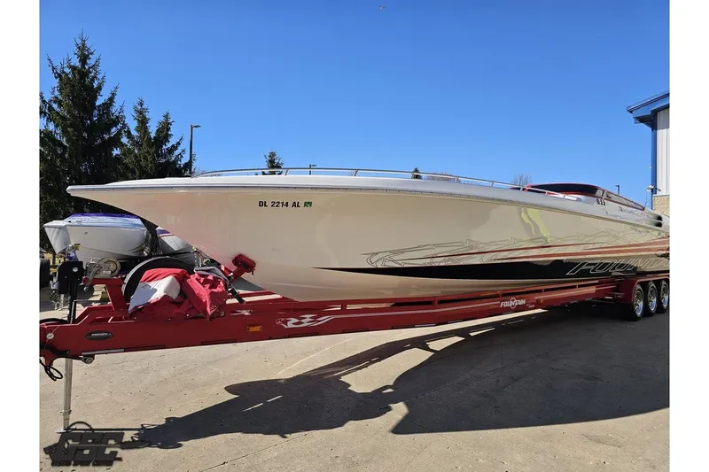 Slide: The Image of 2009 Fountain 47 Lightning boat on red trailer, parked outdoors under clear blue sky. - 17