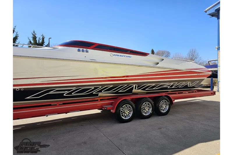 Slide: The Image of 2009 Fountain 47 Lightning speedboat on a red trailer, showcasing sleek design and vibrant graphics. - 20