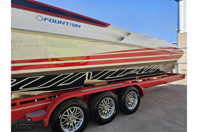 Slide: The Image of 2009 Fountain 47 Lightning boat on a red trailer, showcasing sleek design and vibrant graphics. - 21