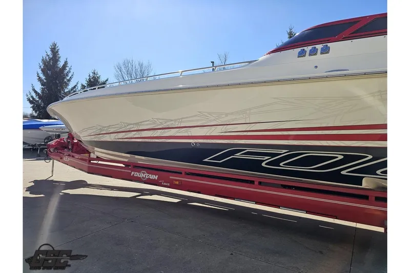 Slide: The Image of 2009 Fountain 47 Lightning boat on red trailer, side view with graphics. - 23