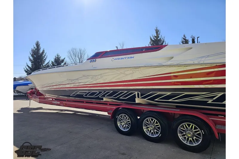 Slide: The Image of 2009 Fountain 47 Lightning speedboat on trailer, featuring sleek design and vibrant graphics. - 24