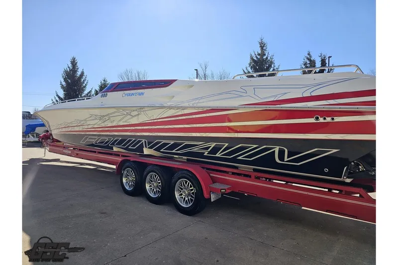 Slide: The Image of 2009 Fountain 47 Lightning speedboat on trailer, featuring bold red and white design. - 25