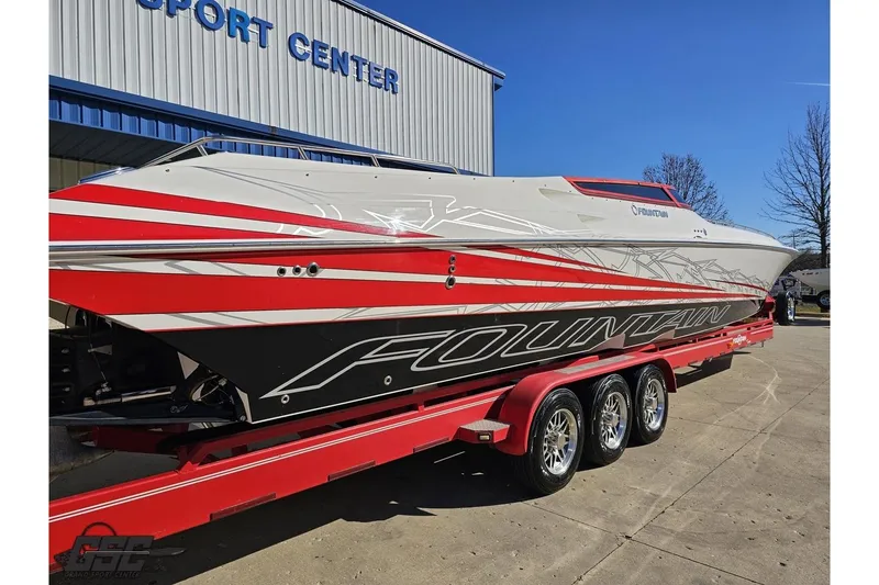 Slide: The Image of 2009 Fountain 47 Lightning speedboat on a red trailer outside a sports center. - 34
