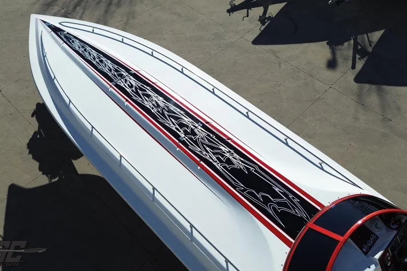 Slide: The Image of 2009 Fountain 47 Lightning speedboat with sleek design and intricate black and red graphics. - 38