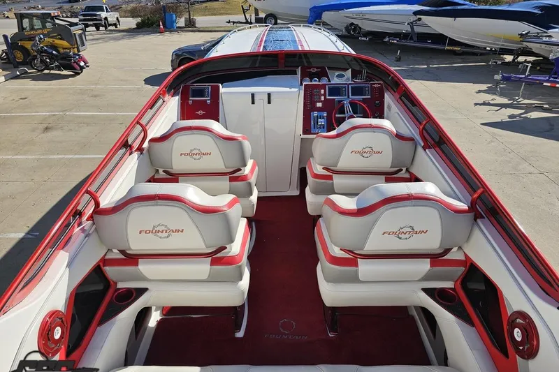 Slide: The Image of 2009 Fountain 47 Lightning boat interior with red and white seating, dashboard, and controls. - 55