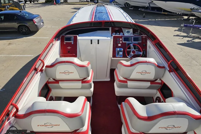 Slide: The Image of 2009 Fountain 47 Lightning boat interior with red and white seating and control panel. - 59