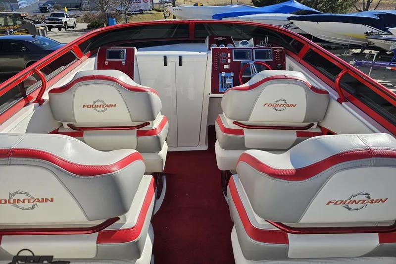 Slide: The Image of 2009 Fountain 47 Lightning boat interior with red and white seating and control panel. - 60