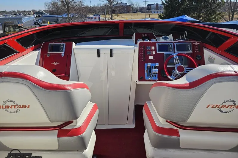 Slide: The Image of Interior of 2009 Fountain 47 Lightning boat with red and white seating and control panel. - 68