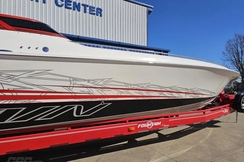 Slide: The Image of 2009 Fountain 47 Lightning boat on red trailer, parked outside a service center. - 7