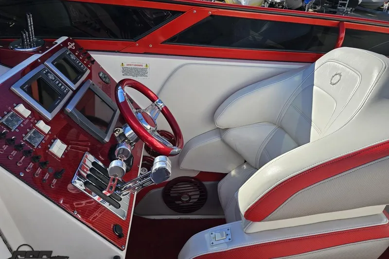 Slide: The Image of 2009 Fountain 47 Lightning boat cockpit with red accents and advanced controls. - 75