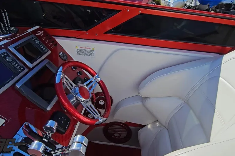 Slide: The Image of Interior of 2009 Fountain 47 Lightning boat with red steering wheel and white seating. - 76