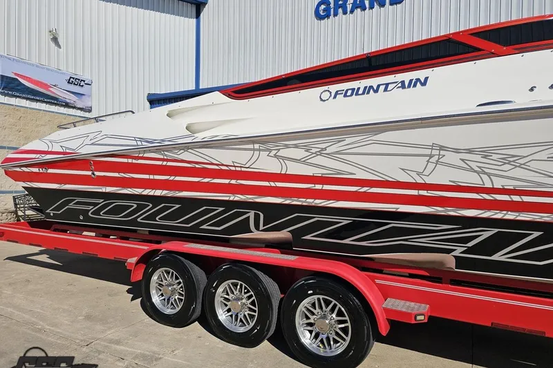 Slide: The Image of 2009 Fountain 47 Lightning boat on red trailer, sleek design with bold graphics. - 8