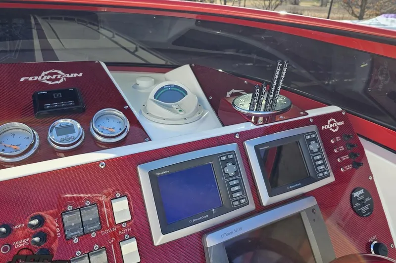 Slide: The Image of Dashboard of 2009 Fountain 47 Lightning boat with gauges and navigation screens. - 84