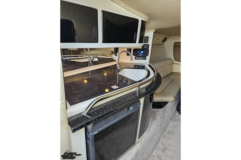 Slide: The Image of 2009 Fountain 47 Lightning boat interior with kitchenette, sink, and seating area. - 90