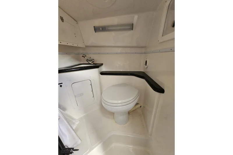 Slide: The Image of 2009 Fountain 47 Lightning boat bathroom with toilet and sink, compact and functional design. - 92